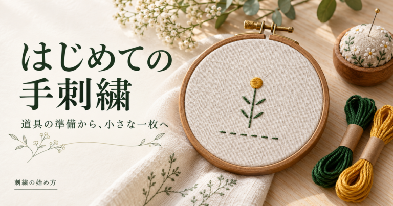 刺繍枠に張った生成りの布と、緑と黄色の糸で刺した小さな植物モチーフ